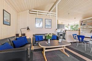 a living room with a couch and a table at 8424-Knebel-Rastestedet-46 in Knebel