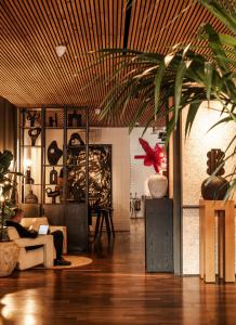 a person sitting on a couch in a living room at One Hundred Shoreditch in London