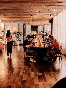 a group of people sitting around a table in a room at One Hundred Shoreditch in London +72 photos