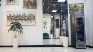a store front with a potted plant on a wall at Arzum Hostel in Tashkent