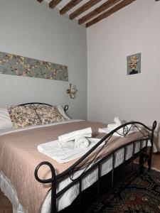 a bedroom with a bed with towels on it at B&B Note di Verdi in Parma