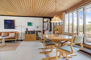 a dining room with a wooden table and chairs at 30486-Odder-Kirkeager-5 in Odder