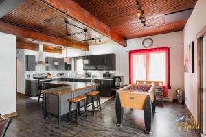 a kitchen with a table with billiards at Front LAKE Simon HOT TUB 6br 17p BEACH private in Lac-Simon