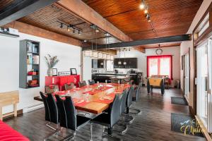 a dining room with a long table and chairs at Front LAKE Simon HOT TUB 6br 17p BEACH private in Lac-Simon +21 photos