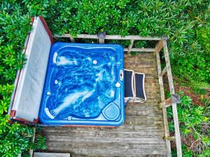 a blue bath tub sitting on top of a hedge at Winds Aloft in Newland