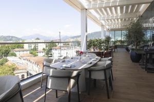 a dining room with a table and chairs on a balcony at Radisson Blu Hotel, Bergamo ChorusLife in Bergamo