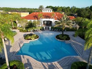 an overhead view of a swimming pool in front of a house at 535 -Villa Belvedere, A Stunning, Spacious 5 Bed Lake View Home with Pool and Spa in Davenport