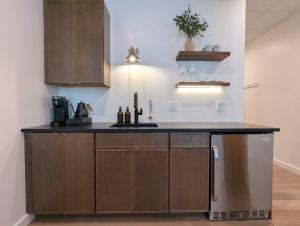 Una cocina con gabinetes de madera y encimera. en The Optimist Guesthouse | 4, en Camden