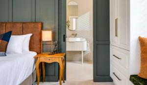 a bedroom with a bed and a table with a night stand at Magnolia - Your Private Luxury Escape Awaits in Scamander