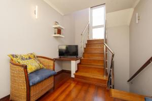 a living room with a wicker chair and a television at B28 - Stylish Typical House in Lagos