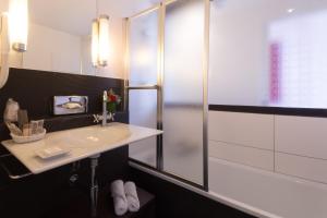 a bathroom with a sink and a shower at Villa 81 in Deauville