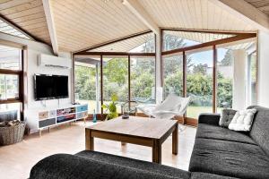 a living room with a couch and a table at 30006-Malling-Laerkevaenget-8 in Malling
