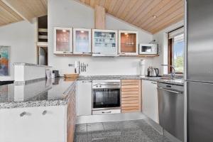 a kitchen with white cabinets and a stainless steel refrigerator at 30006-Malling-Laerkevaenget-8 in Malling