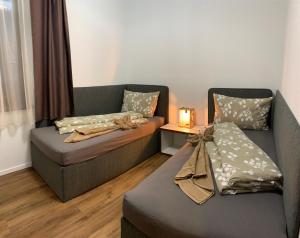 a living room with a couch and a chair at Apartmánový dom Poludnica I., Chopok Juh, Jasná in Tale