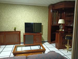 a living room with a flat screen tv on a table at Alojamiento Rural Dilamor in El Picazo