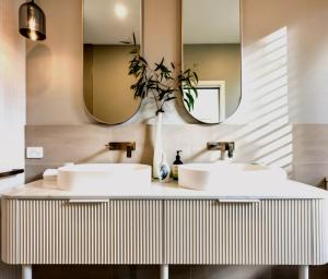 two sinks in a bathroom with two mirrors at Magnolia - Your Private Luxury Escape Awaits in Scamander +22 photos