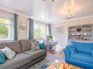 a living room with a couch and a table at Paddock End in Great Plumstead