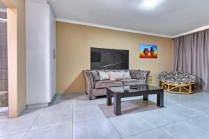 a living room with a couch and a table at 45 on westmoreland in Johannesburg