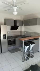 a kitchen with a counter and a table in it at Appartement confortable à Pointe-à-Pitre de 32 m² avec terrasse in Pointe-à-Pitre
