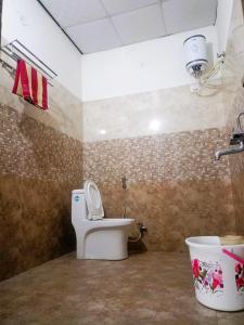 a bathroom with a toilet in a room at The Starlight Farm- Poolside Tent Stay in Jaipur in Jāmb
