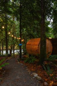 a large wooden boat sitting next to a tree at Mt Pilchuck River Cabin in Granite Falls