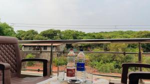 a table with two bottles of water and glasses on it at Stay Classy Inn in Mahabaleshwar