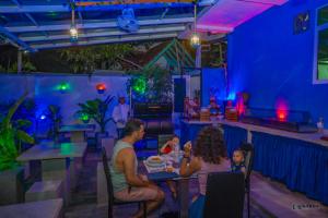 a group of people sitting at a table in a restaurant at Downsouth Cabanas in Habaraduwa