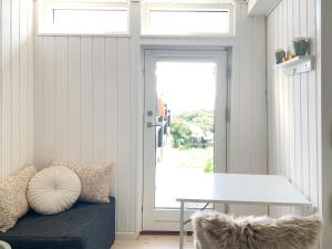 a room with a door with a bench and a window at Beachfront House At Hølken Beach in Odder