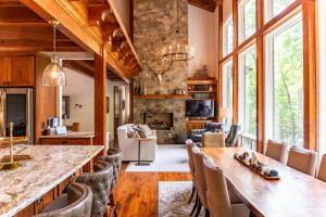a kitchen and living room with a large table and chairs at A Robins Nest in Blowing Rock