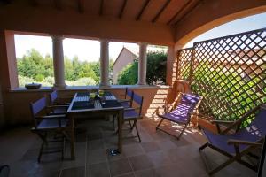 a screened porch with a table and chairs on it at Le Patio in La Cadiere d'Azur