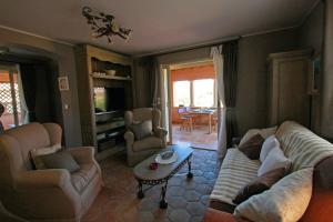 a living room with a couch and chairs and a table at Le Patio in La Cadiere d'Azur