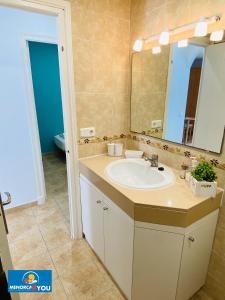 a bathroom with a sink and a mirror at Safir in Son Bou