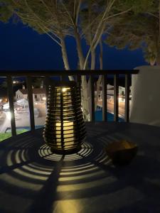 a lit lamp sitting on a table at night at Safir in Son Bou +19 photos