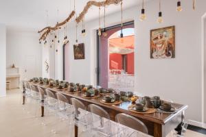 a long table with chairs in a room at Villa Arabesque in Veglie