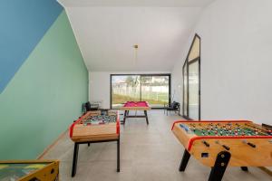 a room with two beds and tables in it at Villa Arabesque in Veglie