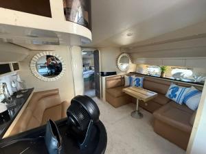 a room with a couch and a table and a mirror at punta excursiones the king of kings in Punta Cana +7 photos