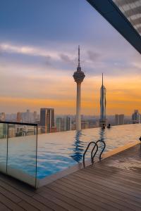 a pool on a roof with a view of a city at Platinum Grand Stay Kuala Lumpur in Kuala Lumpur