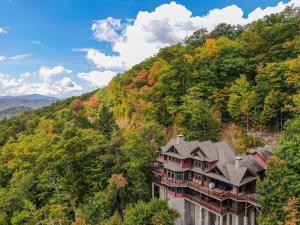 a house on the side of a hill with trees at Overlook Estate in The Farm in Banner Elk