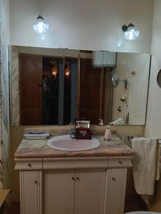 a bathroom with a sink and a large mirror at Sa Torre in Campos