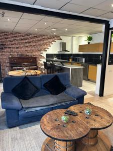 a living room with a blue couch and two tables at LE GARIBALDI - CENTRE VILLE - parking privatif in Limoges