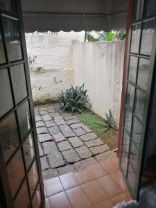 an open door to a patio with a fence at Pousada Estrada Real in Paraty