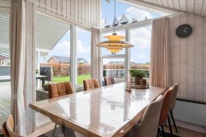 a dining room with a table and chairs and a large window at 30193-Odder-Thorasvej-79 in Odder +23 photos