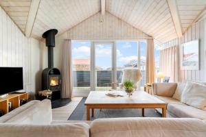 a living room with a couch and a fireplace at 30193-Odder-Thorasvej-79 in Odder