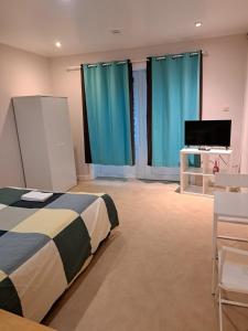 a bedroom with a bed and a flat screen tv at Résidence Rachel 12 in Mons