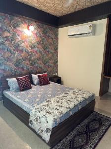 a bedroom with a bed with a floral wallpaper at Taj Nidhi Luxury in Agra