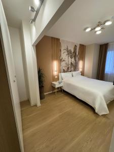 Un dormitorio con una cama y un cuadro en la pared. en ELIOS LIVING - Modern comfort, walking distance to city center & 200m to the beach, en Bordighera