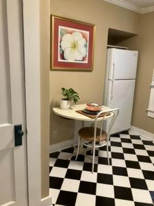 a small kitchen with a table and a refrigerator at Bright 1BR Hideaway Close to UL Lafayette in Lafayette +14 photos