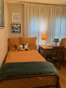 a bedroom with a bed and a table with a table at Bright 1BR Hideaway Close to UL Lafayette in Lafayette