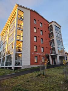 an apartment building with a sign on the side of it at Arctic Willamo Studio- Rovaniemi in Rovaniemi