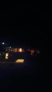 un edificio de noche con luces en la oscuridad en Essence Arenal Spa & Yoga, en El Castillo de La Fortuna